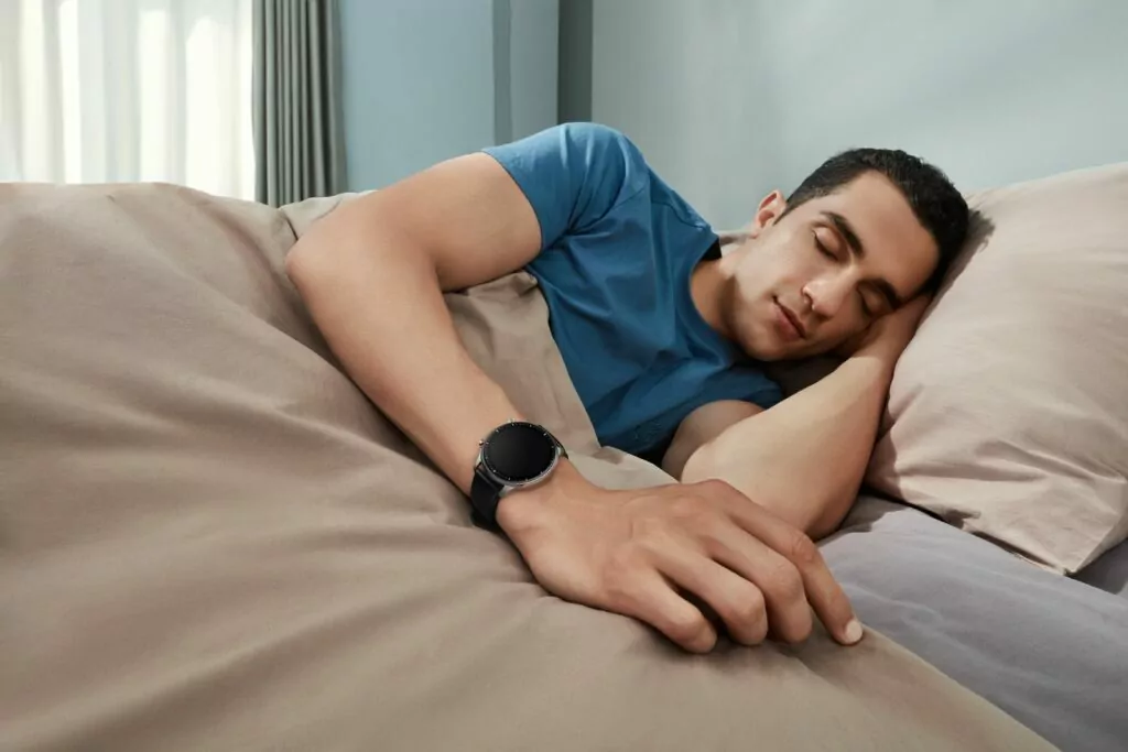 Amazfit GTR 2 classic edition being worn by a man asleep in bed