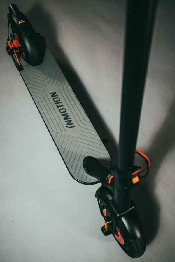 Inmotion Climber Electric Scooter viewed from above and looking down to the rubber deck on a grey background