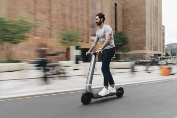 Bo M electric scooter being ridden through the streets