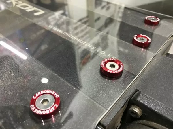 Red aluminium washers fitted to a dualtron electric scooter